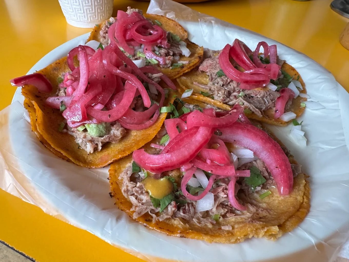 Tacos dorados de chambarete con cebolla morada curtida